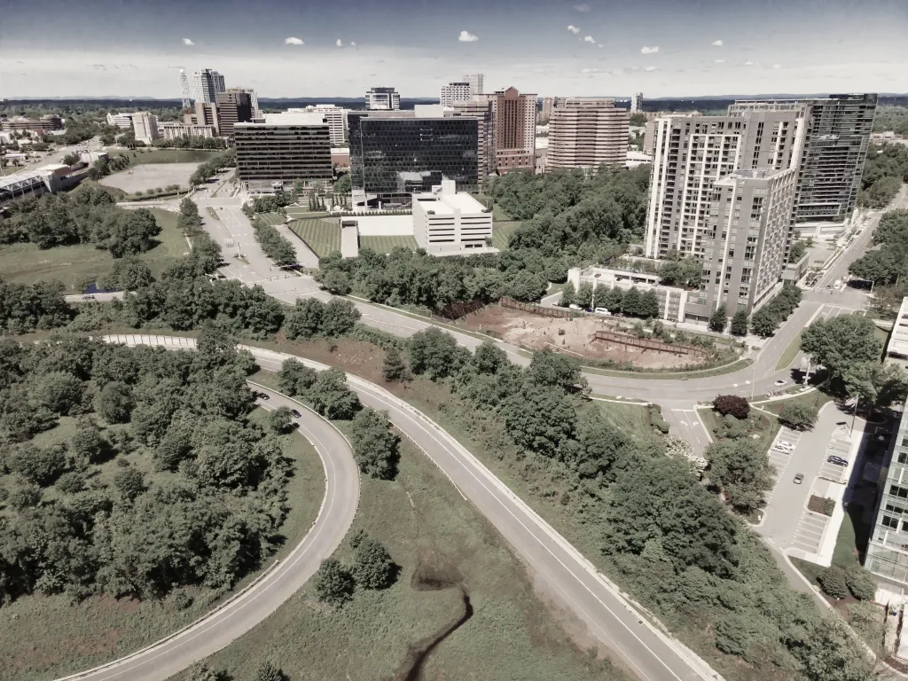 Aerial view of the city skyline, tree-lined roads and office buildings